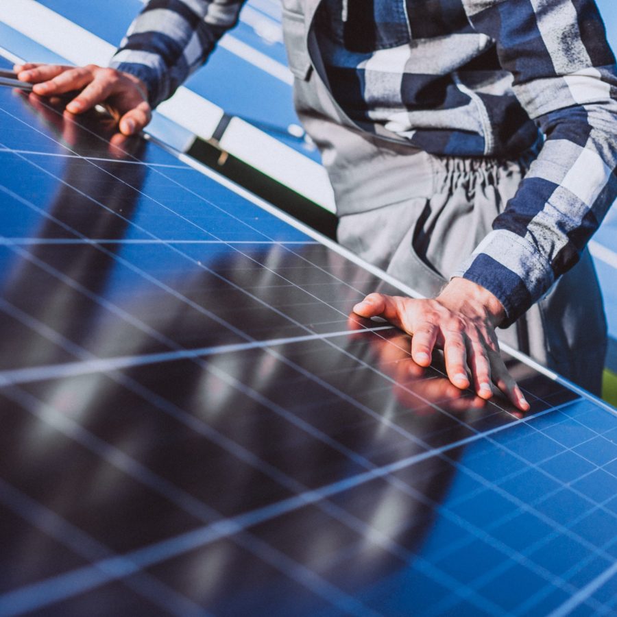 man worker in the firld by the solar panels panneau solaire qualipv